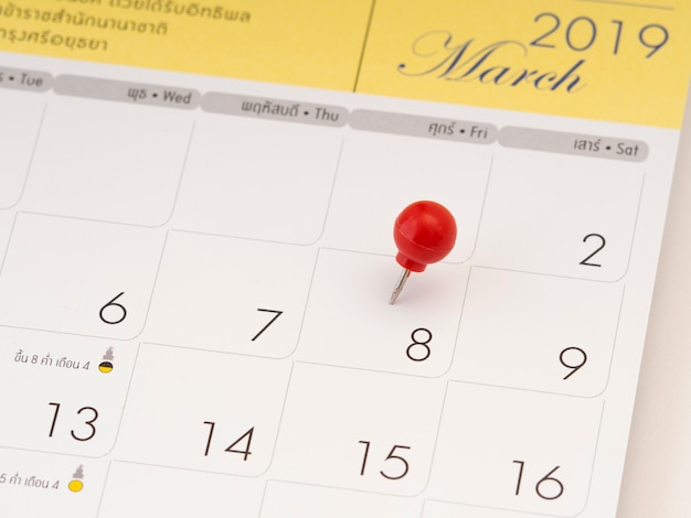 Women's Day on calendar with red pin. 