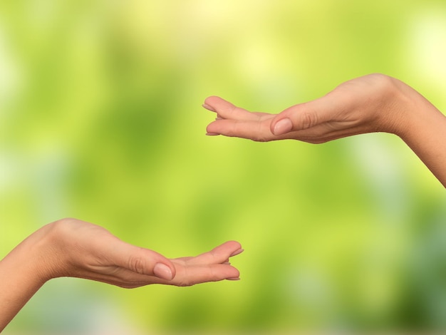 Photo women's empty two palms on boke background. concept. close-up. for design.