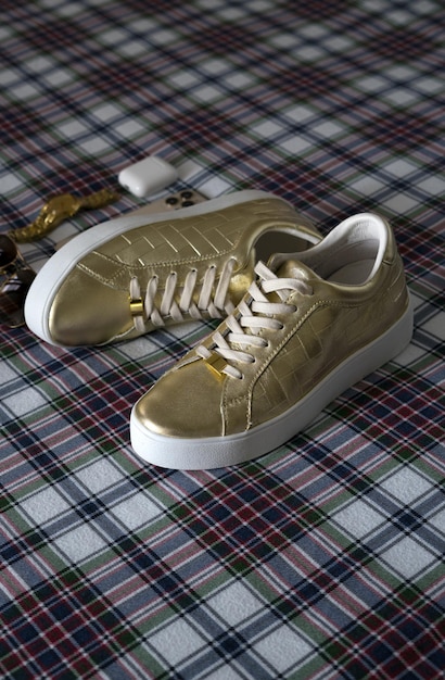 Photo women's gold sport shoes and luxury accessories a close up of footwear