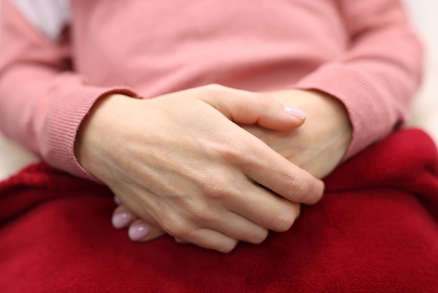 Women's hands are folded together. feminine serenity and self-confidence concept