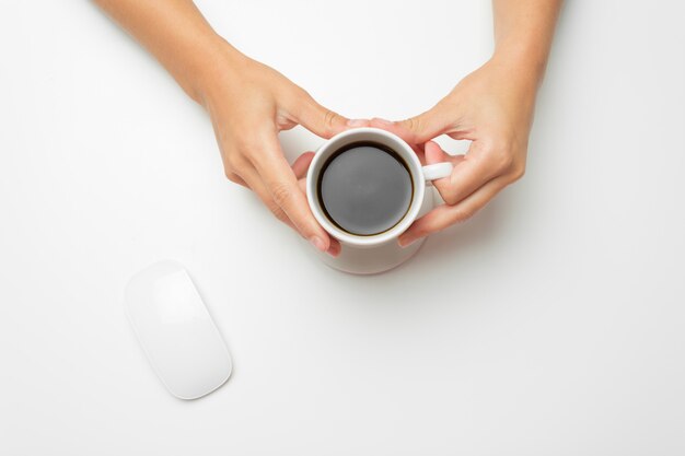 Women's hands, coffee and mouse