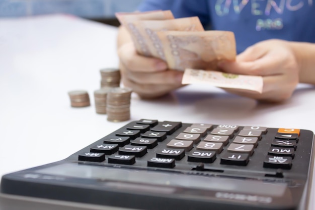 Women's hands count money with stack of coin and calculator a moneysaving concept and investment concept