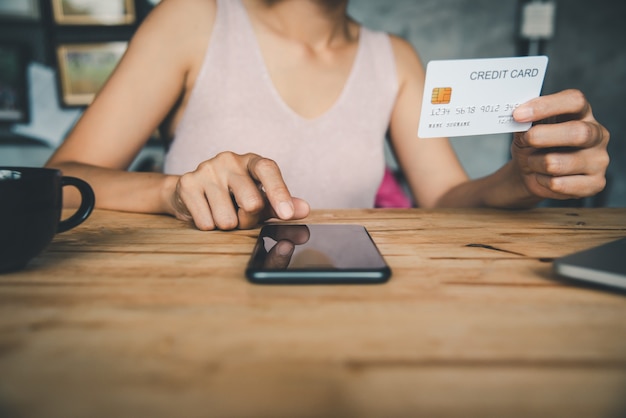 Women's hands holding a credit card and work on laptop Online payment for online shopping