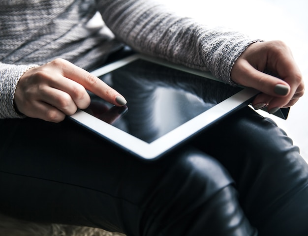 Women's hands holding the tablet. Beautiful manicure. Modern technology, entertainment, recreation, education