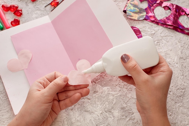 Women's hands make a valentine's day card