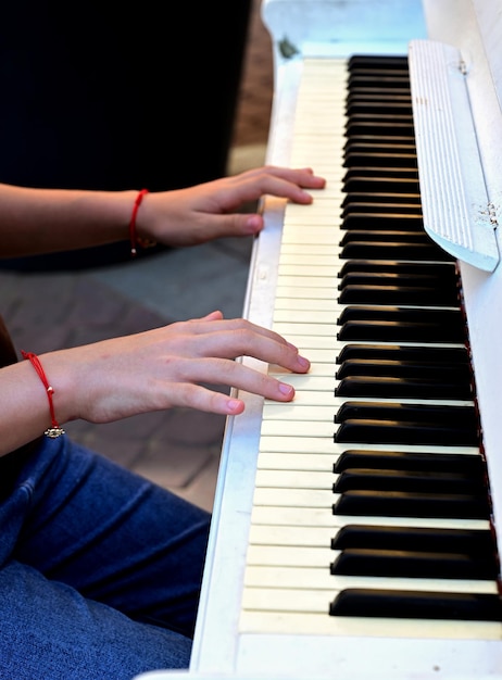 women's hands play the piano