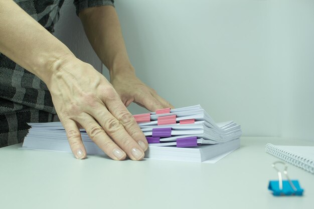 Women's hands sort through papers with information. Business concept.Copy space