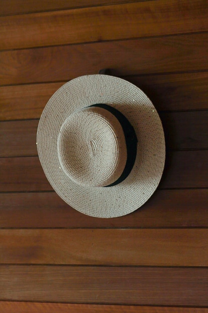 women's hat hanging on a wooden wall