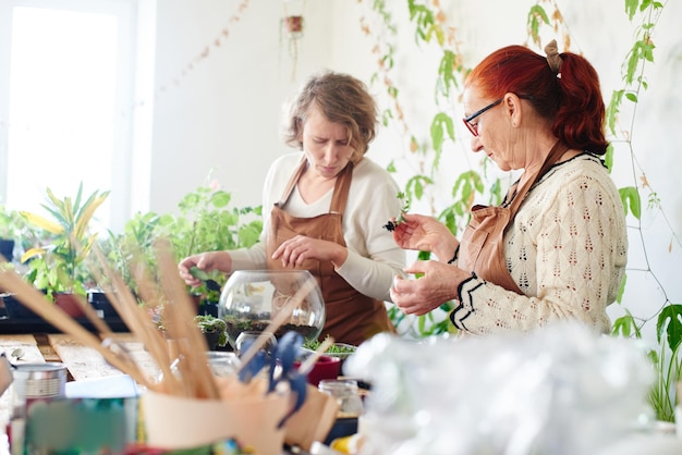 Women's hobby. Mother and daughter botany florists take care of house plants and flowers