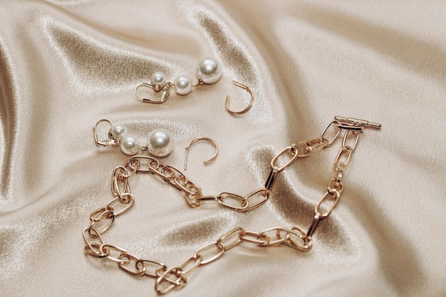 Women's jewelry gold chain trendy jewelry on a silk background