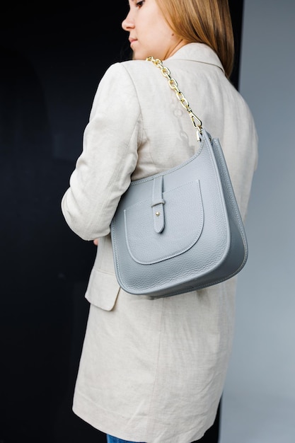 Women's leather stylish handbag A blue everyday bag in a woman's hands