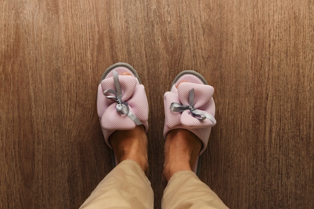 Women's legs in cozy beautiful slippers