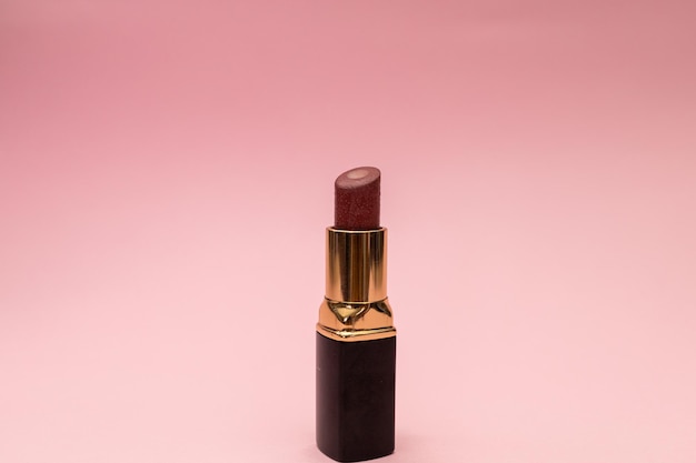 Women's lipstick on a pink background