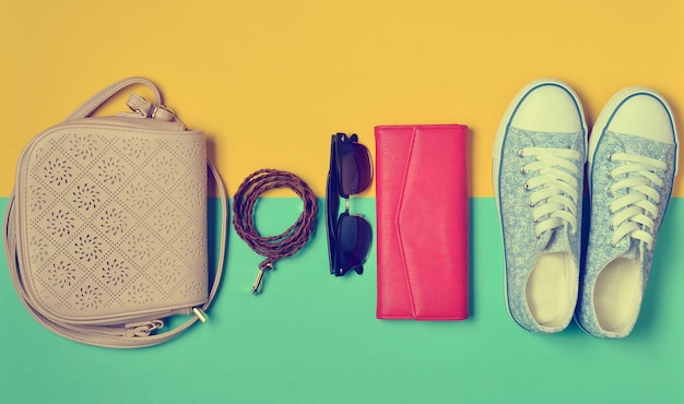 Women's shoes and fashion accessories on a colored background