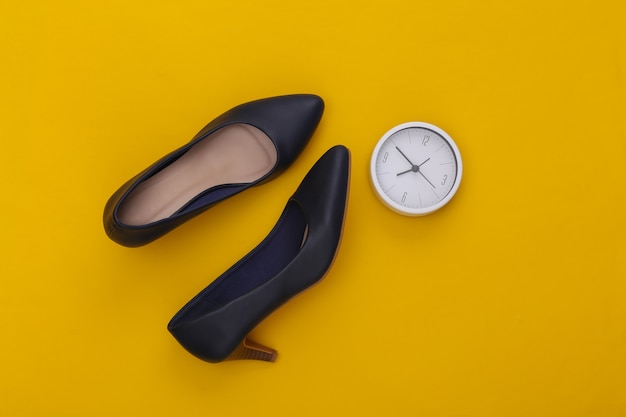 Women's shoes with heels and clock on yellow