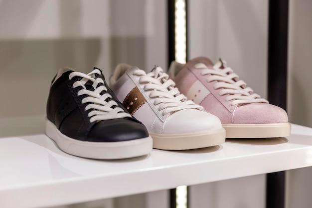 Women's sneakers on display in a store in white pink and black Fashion style and comfort Closeup