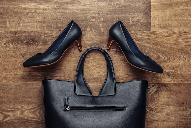 Women's stylish accessories on the floor. Fashionista. High heel shoes, bag. Top view. Flat lay style