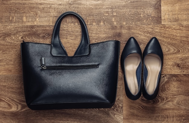 Women's stylish accessories on the floor. Fashionista. High heel shoes, bag. Top view. Flat lay style