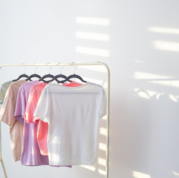 Photo women's tshirts on hanger on white background