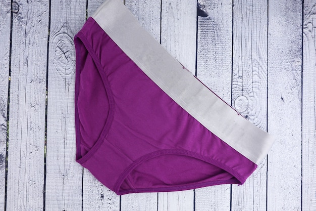 women's underwear purple panties on a wooden