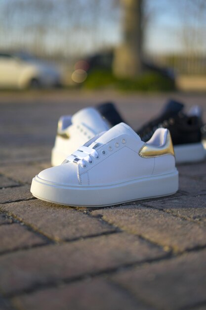 Photo women's white sports shoes a street style in springtime