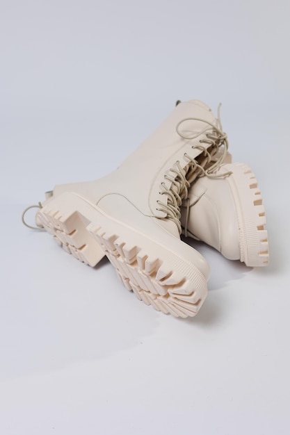 Women's white winter boots with fur with thick soles and laces. Advertising of the new collection of women's shoes 2022