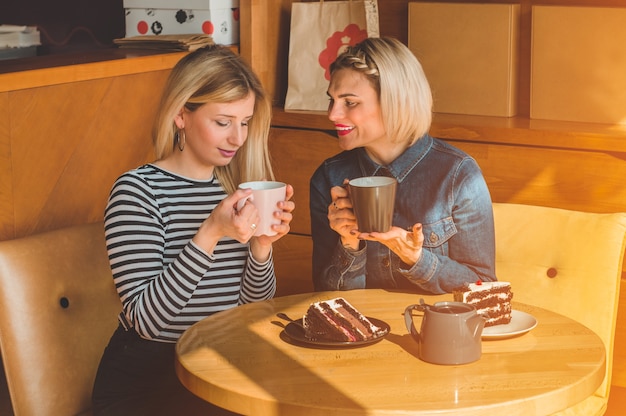 Women sitting in a cafe and drink a hot tea