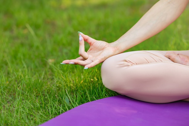 Women sitting in lotus pose, meditating or praying. Healthy lifestyle