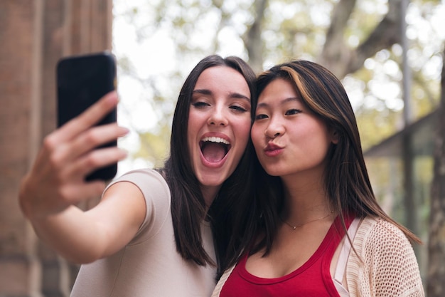 Women smiling and having fun taking a selfie