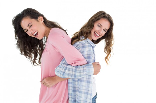 Women standing back-to-back with interlocked hands