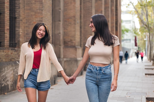 Women strolling through the city holding hands