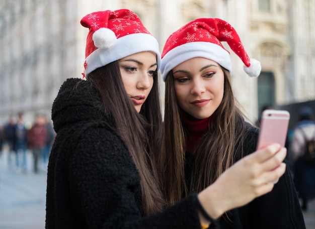 Women taking a selfie while shopping in Milan