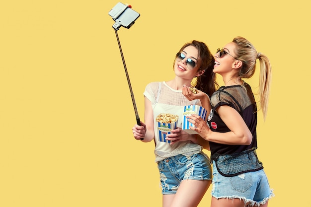 Women taking selfie with popcorn