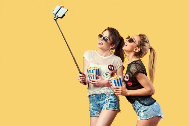 Women taking selfie with popcorn