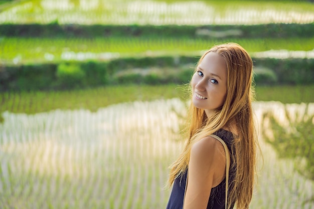 Women tourists enjoy the panoramic view of the beautiful Asian scenery of rice fields