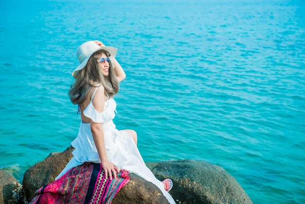 Women travel alone at the sea and beach on Summer. Vacation and relaxing, Chonburi Thailand.