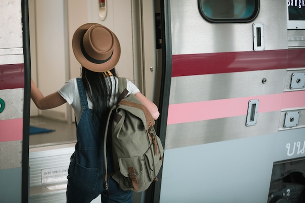 Photo women travel at the train station for a summer trip, travel ideas.