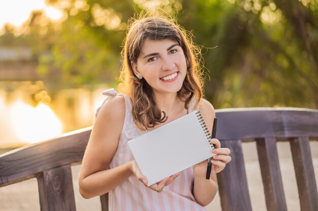 Women in a tropical background holding a signboard paper mockup