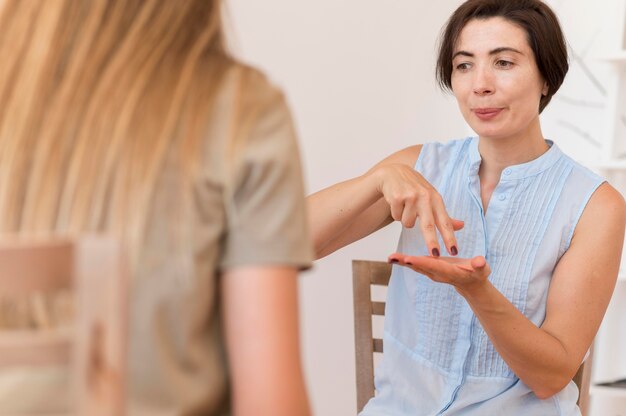 Women using sign language to talk to each other