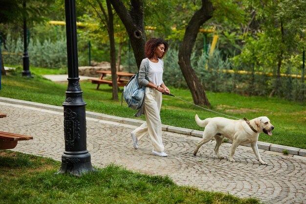 women walking in park with dog