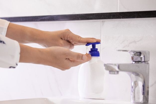 Women washing hands with antibacterial soap sanitizer or alcohol gel for corona covid-19 virus prevention