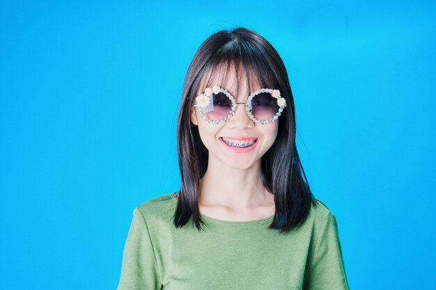 Women wear fashion glasses Showing happy gestures, Blue background.