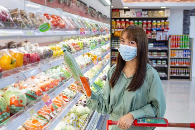 Women wear masks to shop vegetable in supermarkets, new normal lifestyles in the era of the Corona virus or Covid-19 epidemic