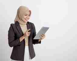 Photo women wearing suits hijab happy working with the tablet formal work concept isolated