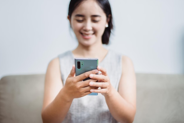 Women who operate mobile phones on sofas, smart phones