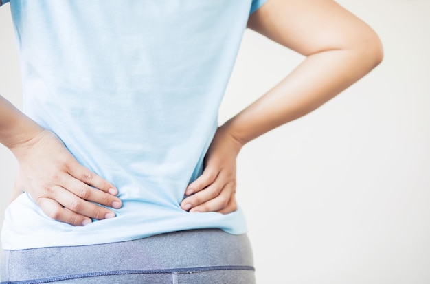 Women with back pain because lifting heavy objects