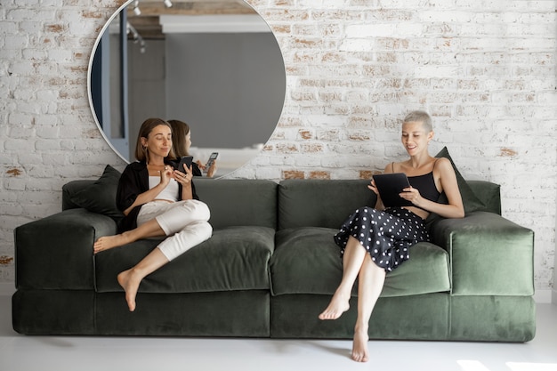 Women with a digital devices at home