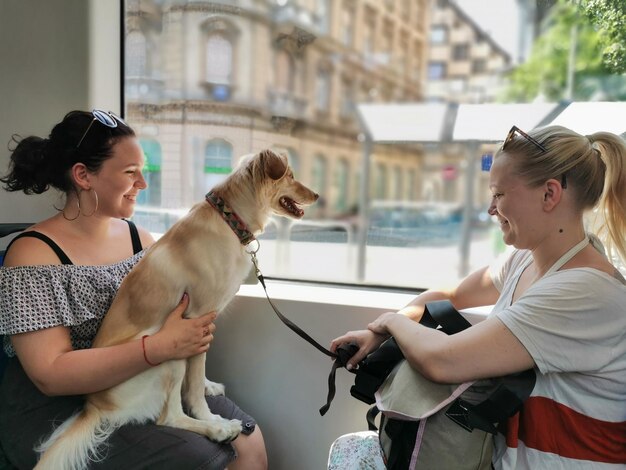 Women with dog sitting by window