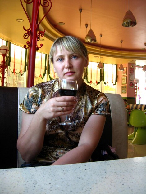 Women with glass of red wine in restaurant