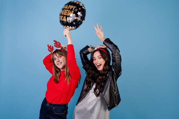 Women with happy new year balloon wearing winter clothes